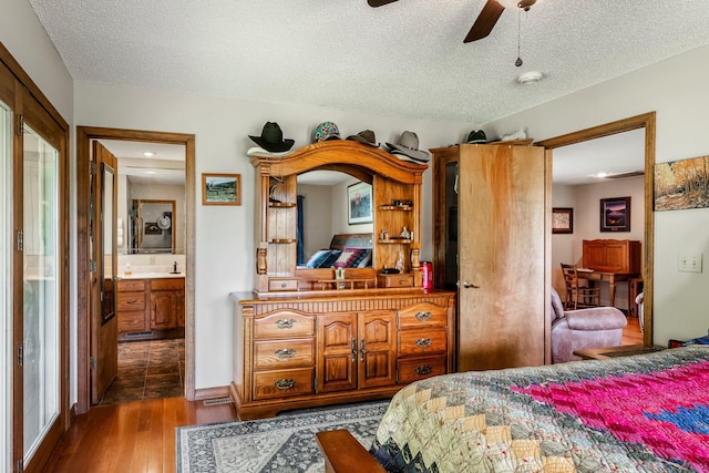 4949 S 196th Rd, Halfway, MO 65663 - bedroom with dark wood-type flooring, a textured ceiling, and a ceiling fan