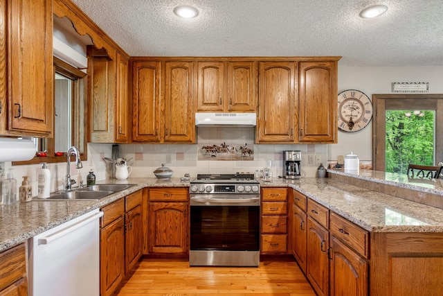 4949 S 196th Rd, Halfway, MO 65663 - kitchen with stainless steel stove, under cabinet range hood, white dishwasher, a sink, and a textured ceiling