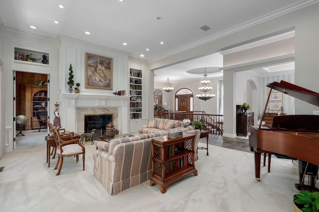 5245 S Stonehaven Dr, Springfield, MO 65809 - living room with ornamental molding, a fireplace, recessed lighting, built in features, and a chandelier