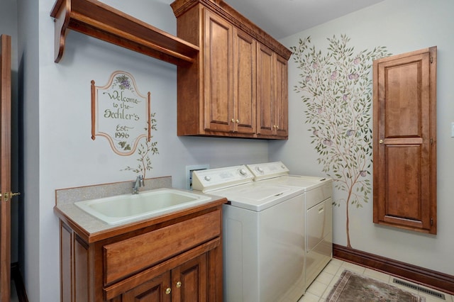 5245 S Stonehaven Dr, Springfield, MO 65809 - clothes washing area with cabinet space, washer and clothes dryer, and light tile patterned flooring