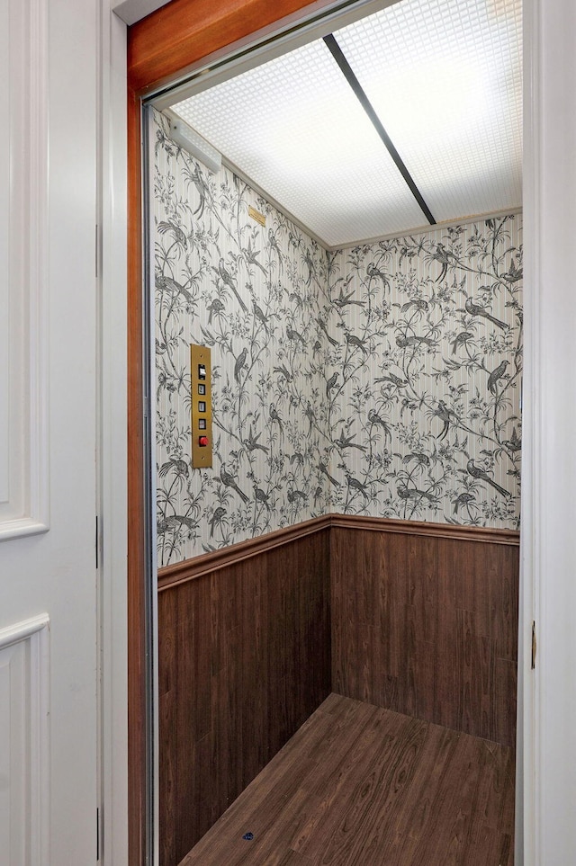 5245 S Stonehaven Dr, Springfield, MO 65809 - empty room with wallpapered walls, wainscoting, elevator, and wooden walls