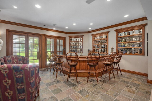 5245 S Stonehaven Dr, Springfield, MO 65809 - dining space featuring bar, recessed lighting, crown molding, baseboards, and stone finish flooring