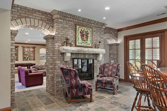 5245 S Stonehaven Dr, Springfield, MO 65809 - living area with stone finish floors, ornamental molding, a brick fireplace, recessed lighting, and baseboards