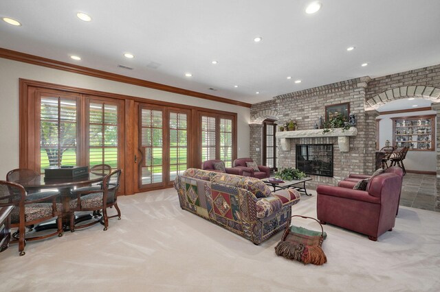 5245 S Stonehaven Dr, Springfield, MO 65809 - living area with light carpet, ornamental molding, recessed lighting, plenty of natural light, and a fireplace