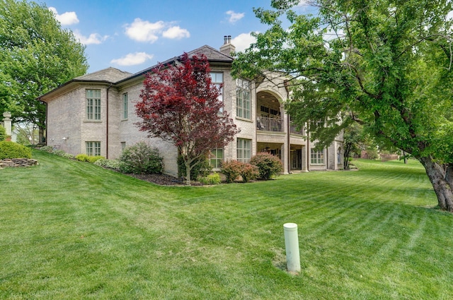 5245 S Stonehaven Dr, Springfield, MO 65809 - back of house with a chimney, a yard, and a balcony