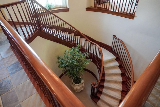 5245 S Stonehaven Dr, Springfield, MO 65809 - staircase featuring stone tile flooring and baseboards