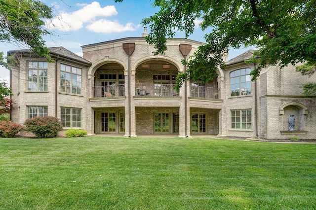 5245 S Stonehaven Dr, Springfield, MO 65809 - rear view of house with a balcony, a lawn, brick siding, and french doors
