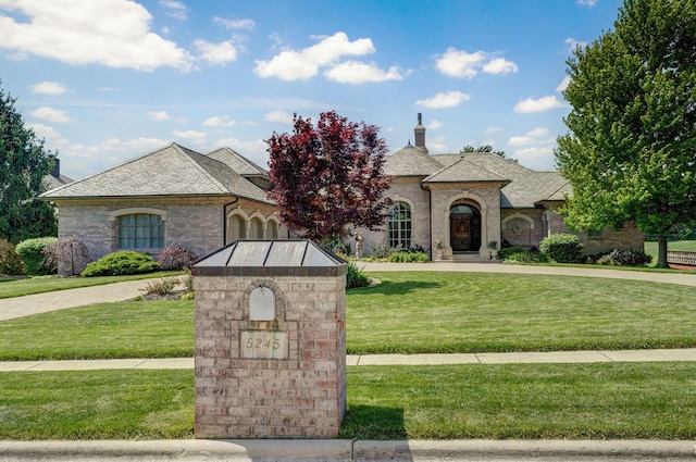 5245 S Stonehaven Dr, Springfield, MO 65809 - french country style house with a front lawn and a chimney
