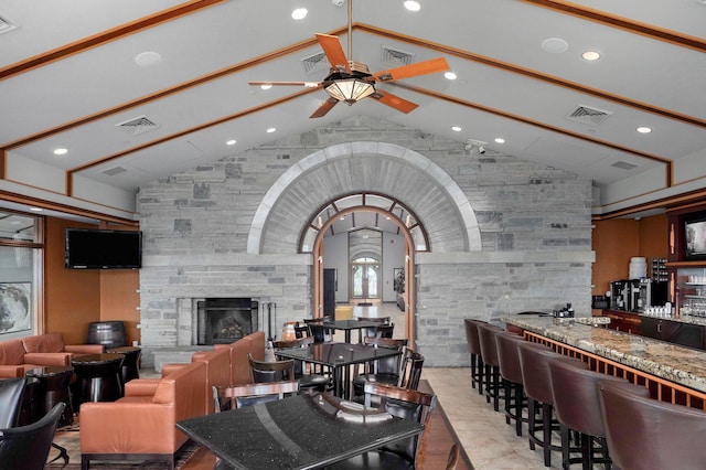 5245 S Stonehaven Dr, Springfield, MO 65809 - dining area with lofted ceiling, a ceiling fan, a fireplace, recessed lighting, and a community bar