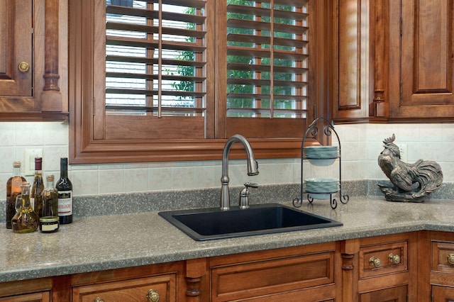 5245 S Stonehaven Dr, Springfield, MO 65809 - kitchen with a sink, brown cabinetry, backsplash, and plenty of natural light