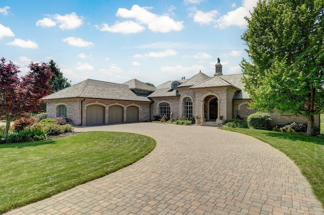 5245 S Stonehaven Dr, Springfield, MO 65809 - french provincial home featuring stone siding, curved driveway, an attached garage, and a front lawn