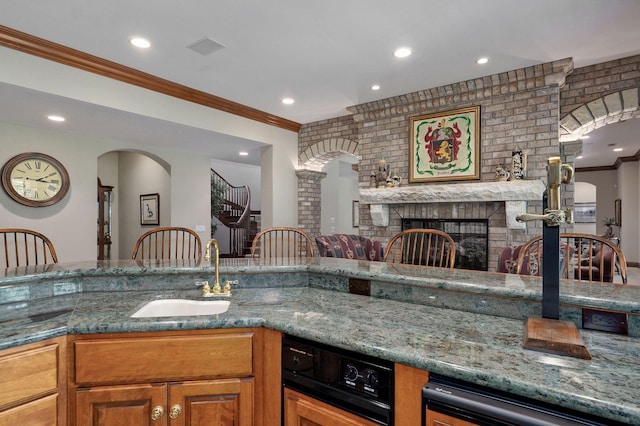 5245 S Stonehaven Dr, Springfield, MO 65809 - kitchen with a sink, crown molding, stone counters, recessed lighting, and a brick fireplace