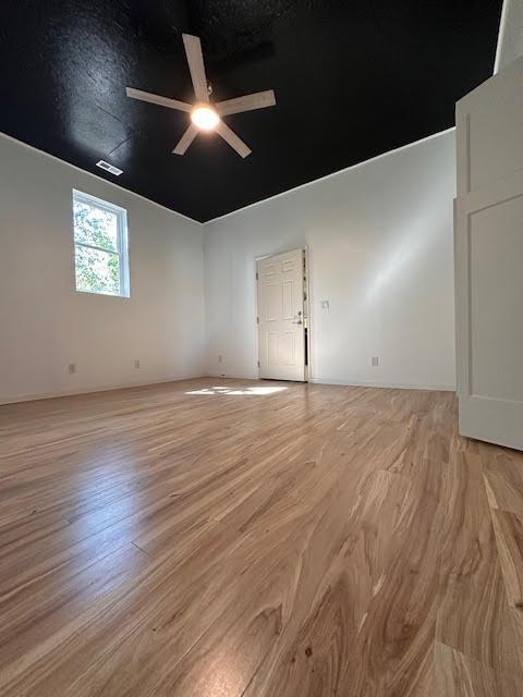 unfurnished room with ceiling fan and light wood-style floors