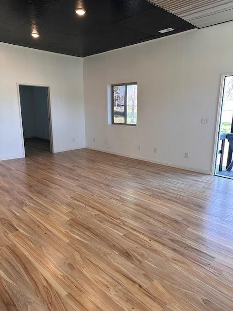 unfurnished room with light wood-style flooring