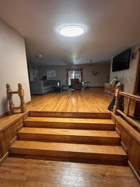 living room with wood finished floors and stairway