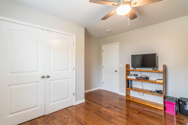 bedroom featuring wood finished floors, baseboards, a closet, and ceiling fan