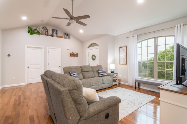 living area with lofted ceiling, ceiling fan, light wood-type flooring, recessed lighting, and baseboards