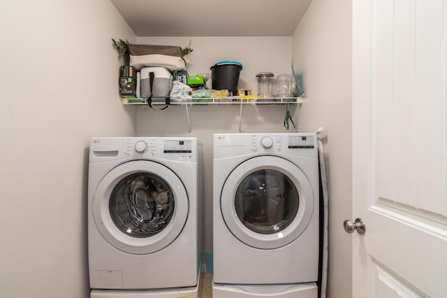 clothes washing area featuring separate washer and dryer