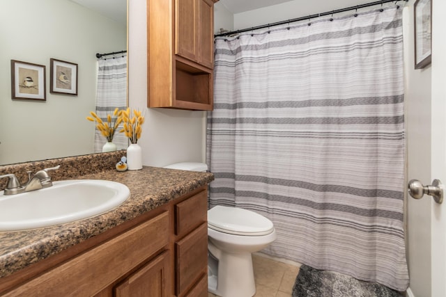 bathroom featuring toilet, vanity, tile patterned floors, and a shower with curtain