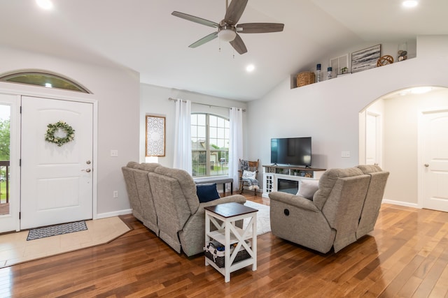living room with wood finished floors, ceiling fan, arched walkways, recessed lighting, and high vaulted ceiling