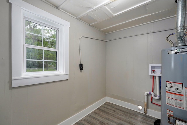 clothes washing area featuring gas water heater, dark wood-style floors, hookup for a washing machine, and baseboards