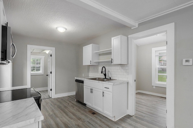 kitchen with stainless steel dishwasher, open shelves, a sink, tasteful backsplash, and white cabinetry