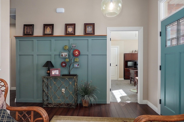entryway featuring dark wood-style flooring and baseboards