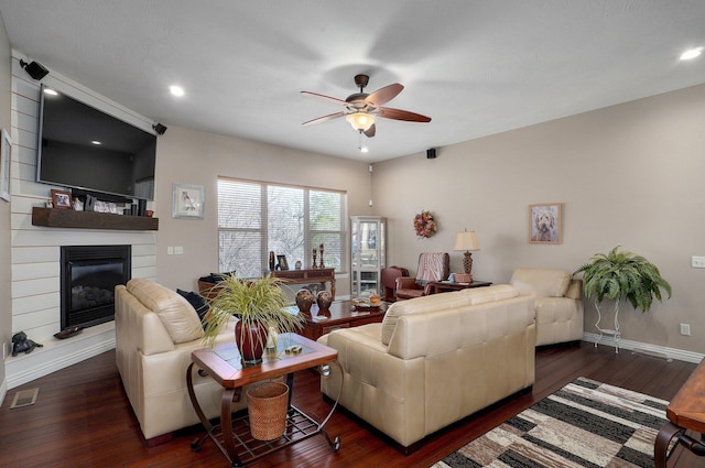 living area with ceiling fan, wood finished floors, a fireplace, and recessed lighting