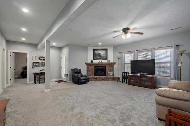 carpeted living room featuring baseboards, a ceiling fan, recessed lighting, and a brick fireplace