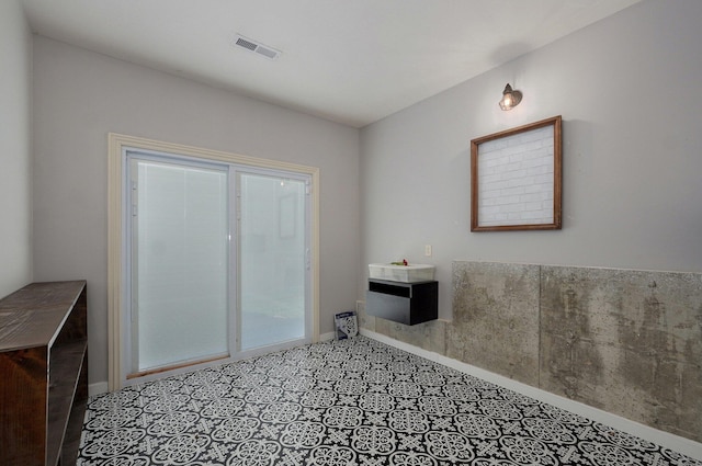 bathroom featuring baseboards and tile patterned floors