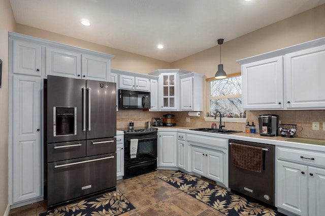 kitchen with black appliances, a sink, white cabinetry, tasteful backsplash, and recessed lighting