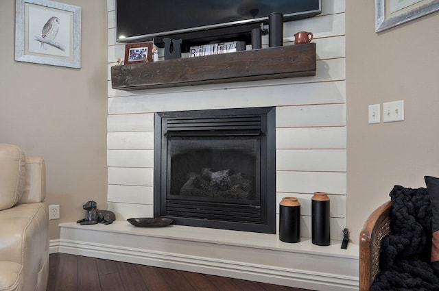 detailed view of a fireplace and wood finished floors