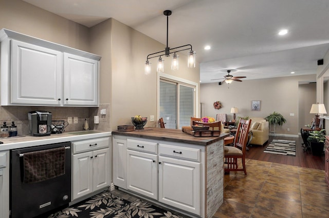 kitchen featuring dishwasher, ceiling fan, open floor plan, a peninsula, and tasteful backsplash