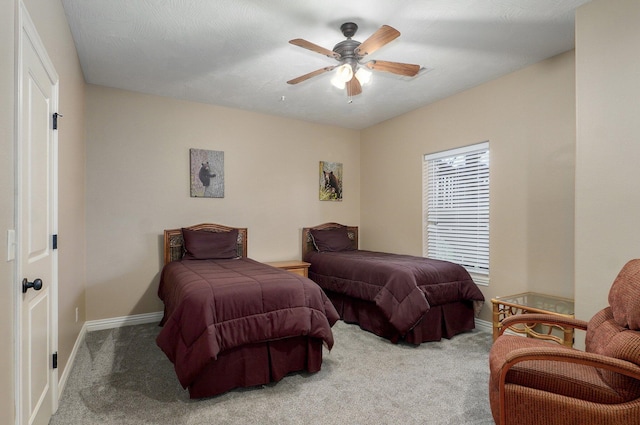 carpeted bedroom featuring baseboards and ceiling fan