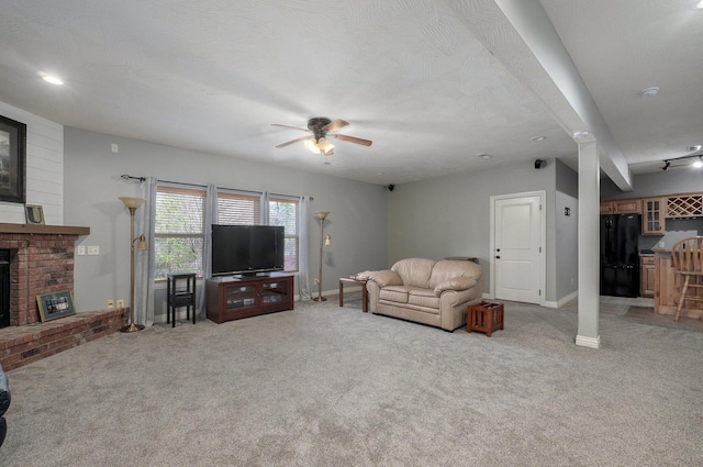 living area featuring a fireplace, light colored carpet, ceiling fan, and baseboards