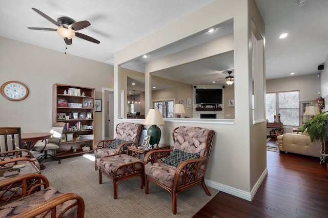 living room with ceiling fan, wood finished floors, baseboards, and recessed lighting