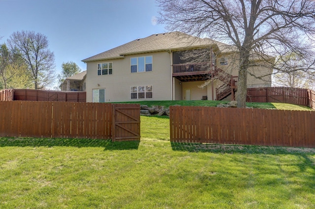 back of property with a wooden deck and stairway