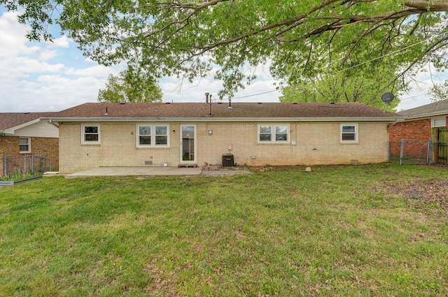 rear view of house with a patio, brick siding, central AC unit, and crawl space
