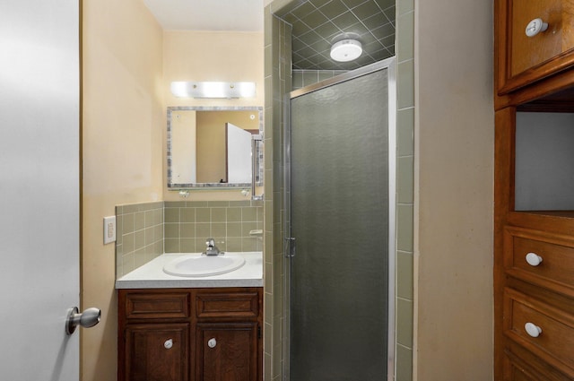 bathroom featuring a stall shower, tasteful backsplash, and vanity