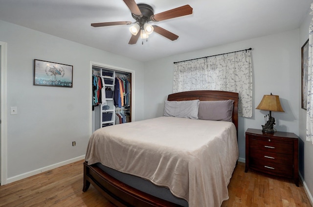 bedroom featuring baseboards, wood finished floors, a closet, and a ceiling fan