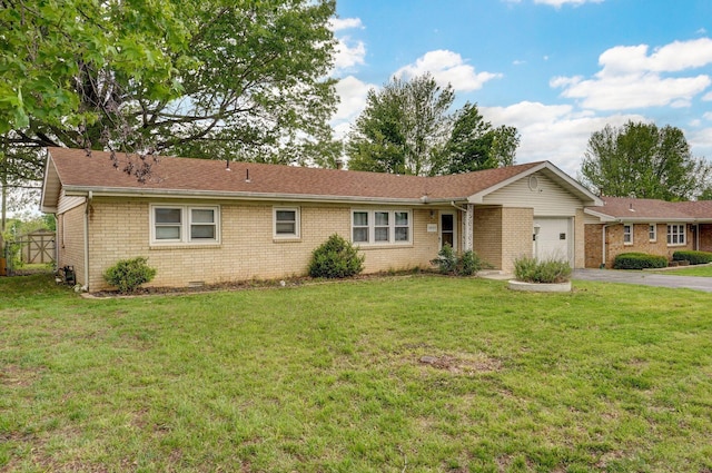 ranch-style house with an attached garage, asphalt driveway, brick siding, and a front yard