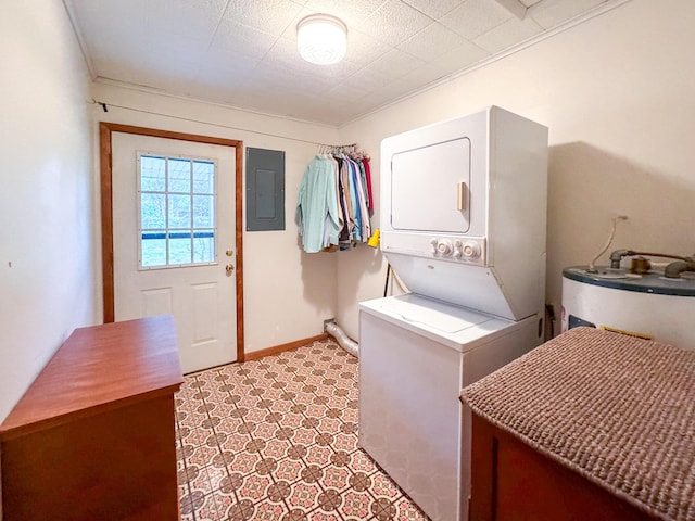 laundry area featuring stacked washer / drying machine, electric panel, water heater, baseboards, and crown molding