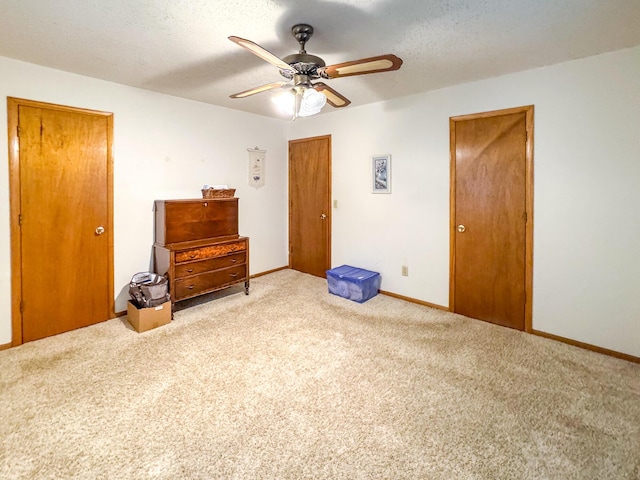 carpeted bedroom featuring baseboards, ceiling fan, and a closet