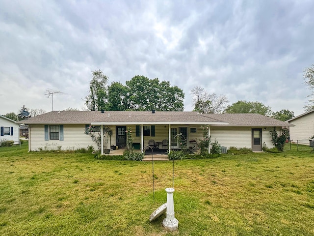 rear view of property with a patio and a yard