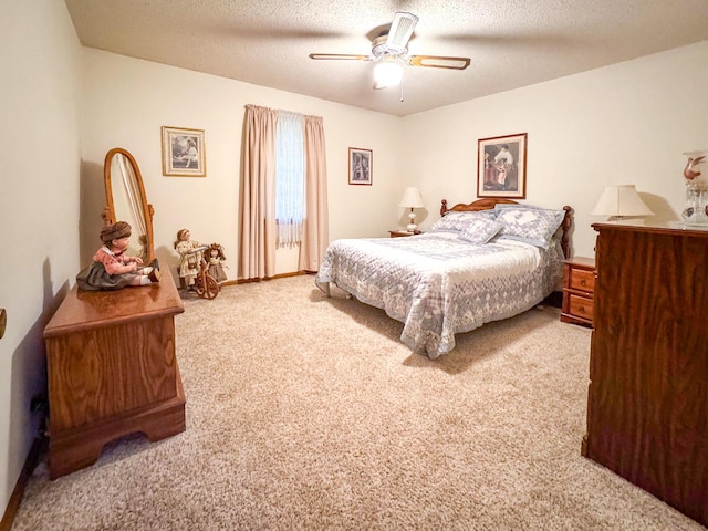 carpeted bedroom featuring a textured ceiling, ceiling fan, and baseboards