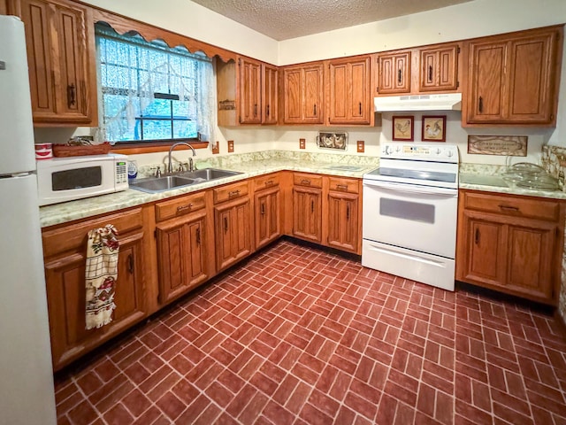 kitchen with white appliances, a sink, brick patterned floors, light countertops, and brown cabinetry