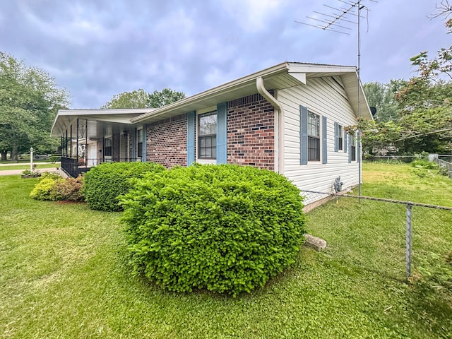 view of side of home featuring brick siding