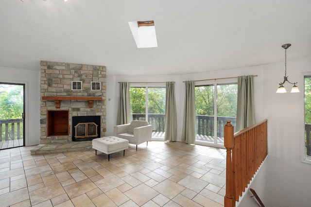 living area with a skylight, a fireplace, and light stone finish floors