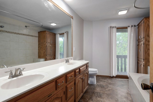 bathroom with healthy amount of natural light, toilet, a bathtub, and double vanity
