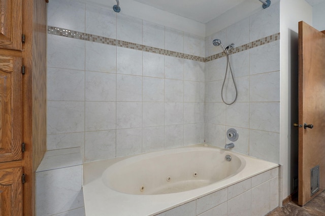 bathroom with a combined bath / shower with jetted tub